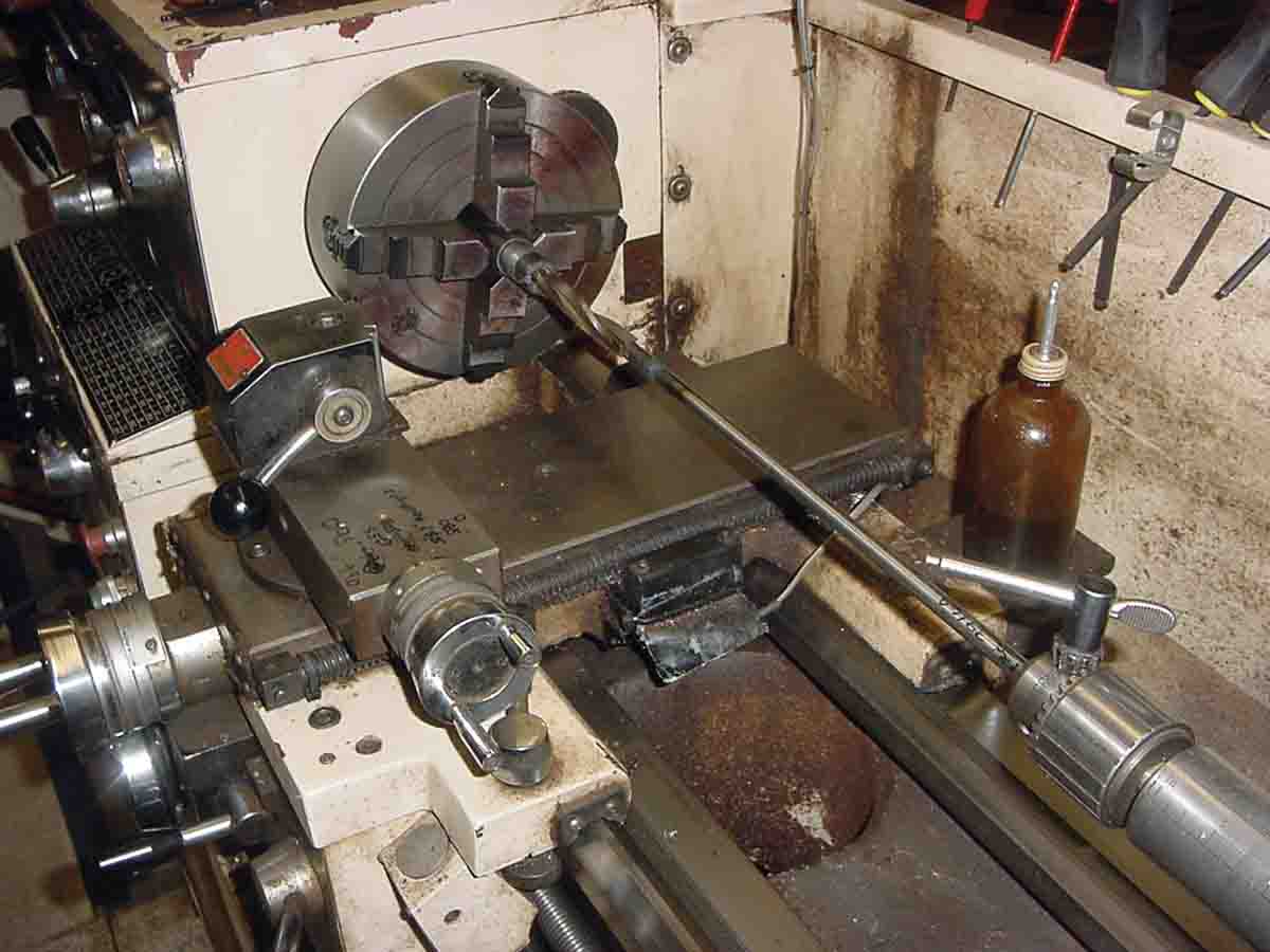 Drilling begins on the sleeved barrel that has been centered in the four-jaw chuck.